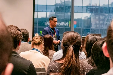 Attendees engaging with a speaker during a summit keynote session
